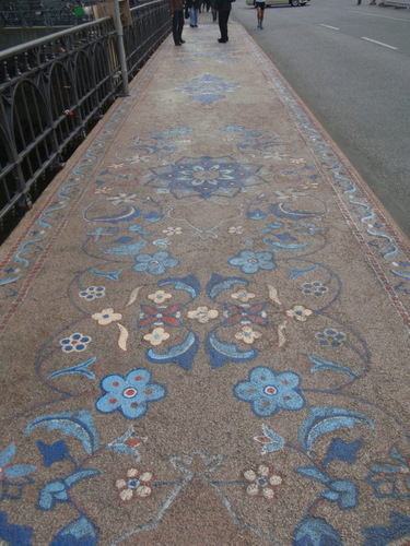 Decorations on the foot path of a bridge crossing.